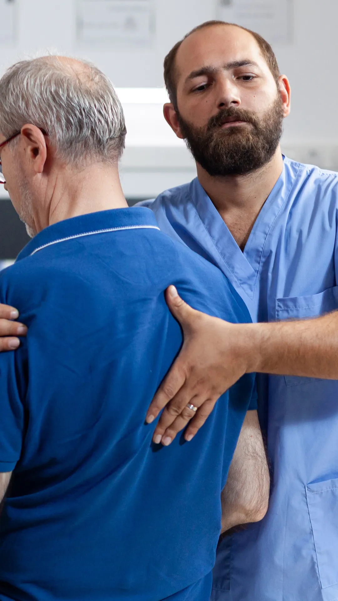 Clinician assisting an older patient with mobility support, representing orthopaedic medical negligence claims and recovery.