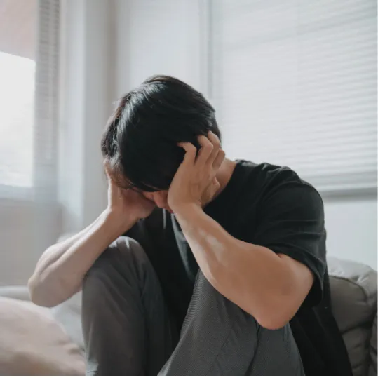 Person sitting with head in hands, showing severe distress, representing mental health injury and psychiatric negligence claims.